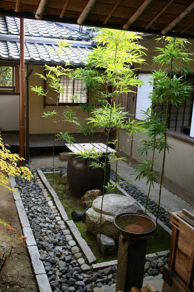 Jardín zen con paisajismo minimalista, asientos tranquilos y elementos  naturales.